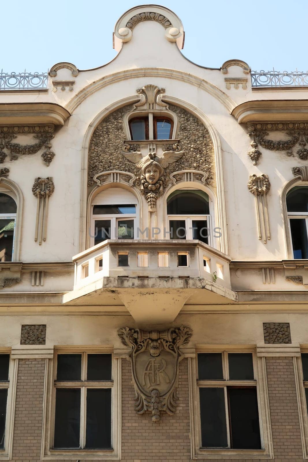 The balcony on the elaborate facade of the Aron Levi Trading house, surrounded by ornaments and reliefs, an example of Art Nouveau architecture in the city center of Belgrade, Serbia 2022
