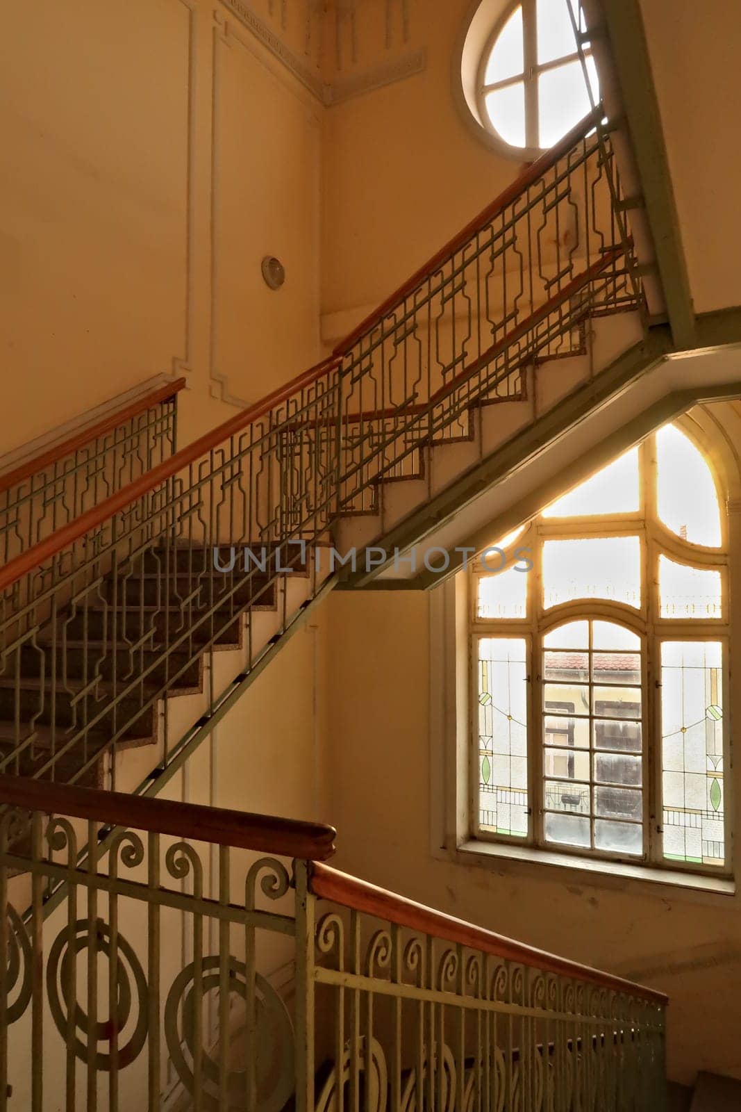 Stairwell, staircase inside the Menraths, Menrats Palace with elaborate handrails and stained glass windows, an example of Art Nouveau architecture in the city center, old town of Novi Sad, Serbia 2022