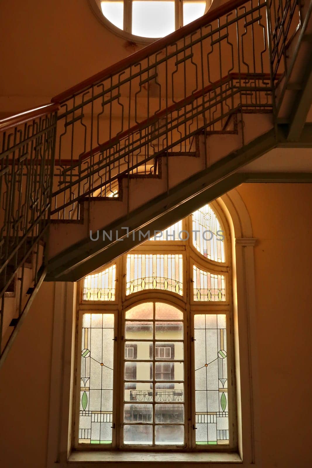 Stairs, handrails and stained glass window inside the Menraths, Menrats Palace, an example of Art Nouveau architecture in the city center, old town of Novi Sad, Serbia 2022