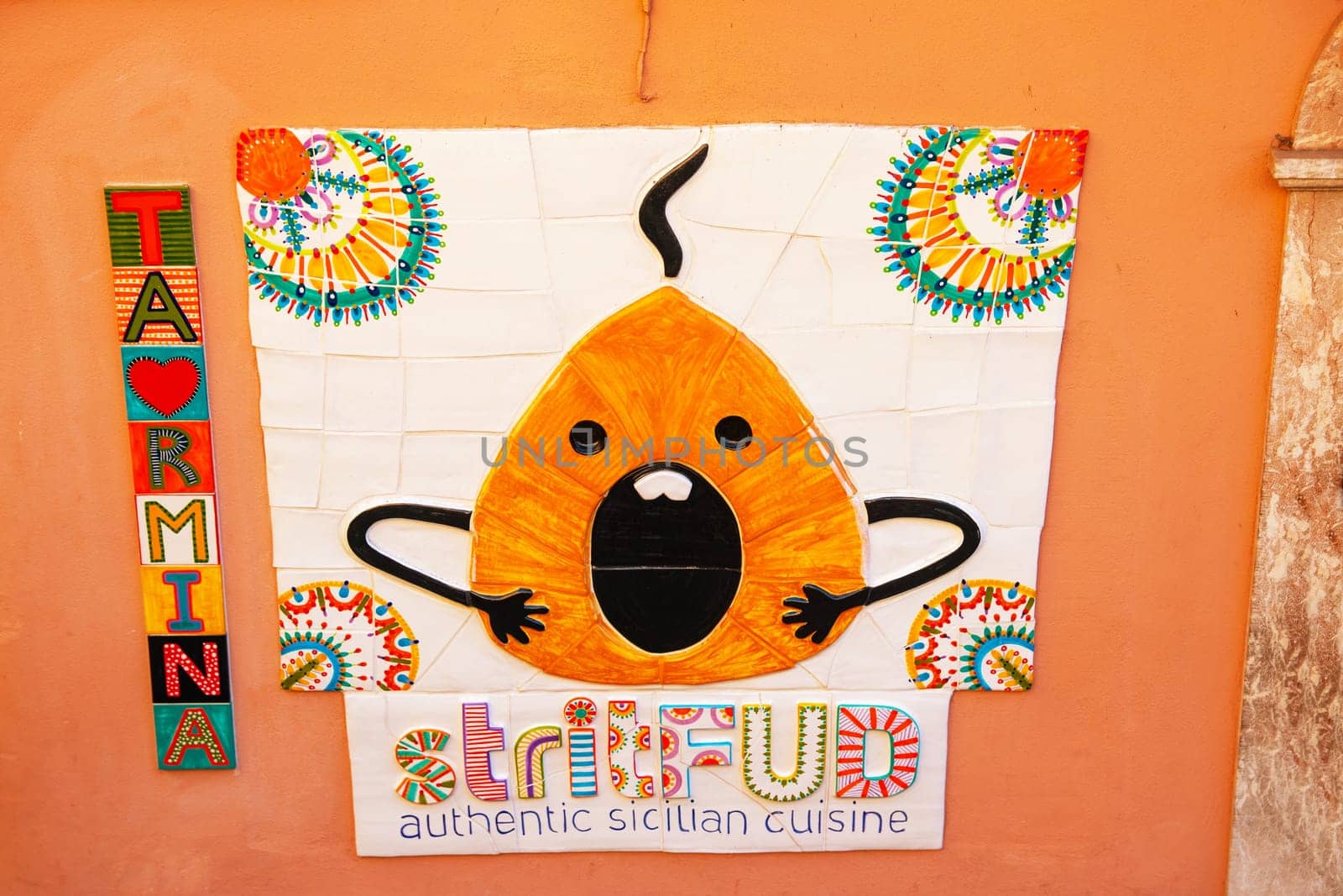 Sicily, Taormina, Italy - 28 Sep 2023. Ceramic advertisement on a wall for a street food (Strit Fud) restaurant in Via di Giovanni in centre of Taormina.