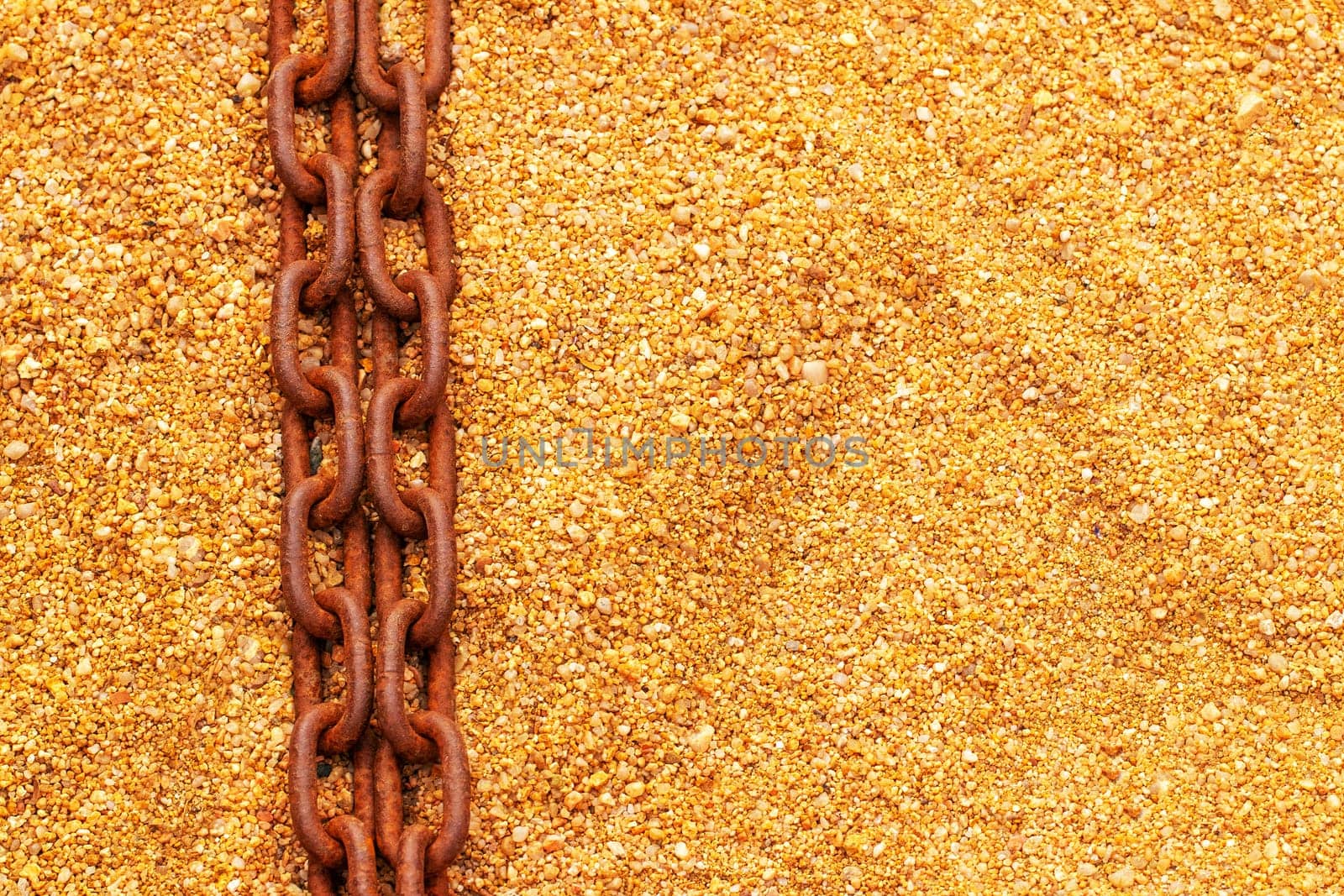 Rusty chains. Selective focus on two old big rusty ships anchor chains on the sand near the sea with large copy space. Abstract background on sand. Macro.