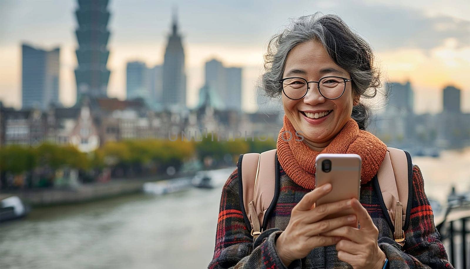 Happy Asian woman using mobile phone making a video call or taking selfie during travel enjoy urban outdoor lifestyle travel city street on holiday vacation.