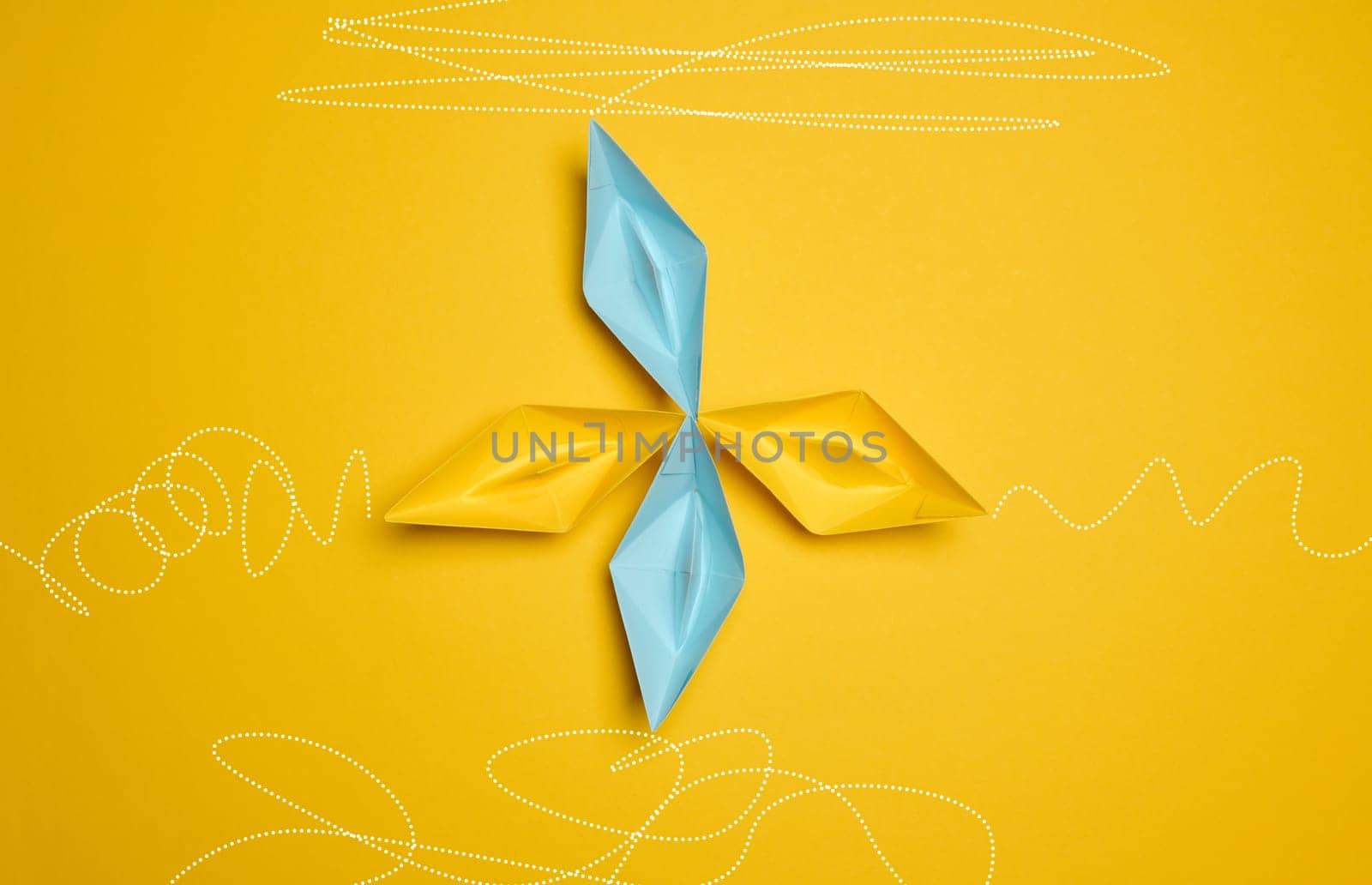 Four paper boats stand at the same departure point, but different trajectories are drawn. The concept of uniqueness, everyone has their own path