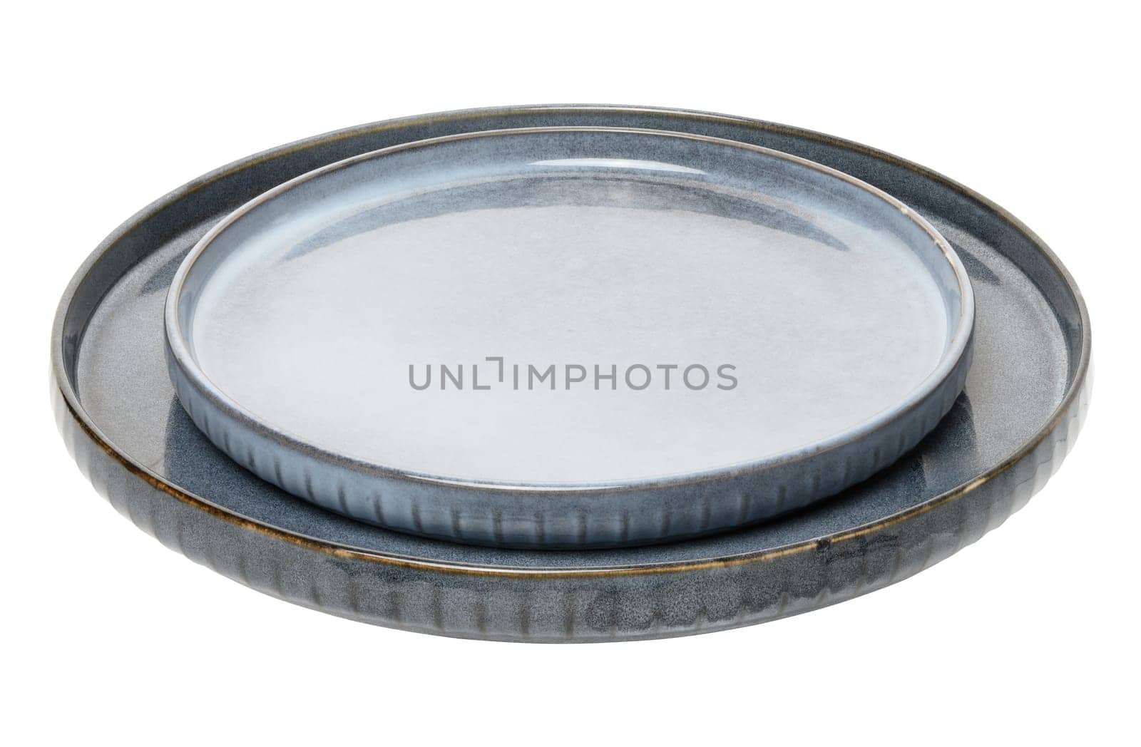 Empty blue round ceramic plate at an angle on isolated background