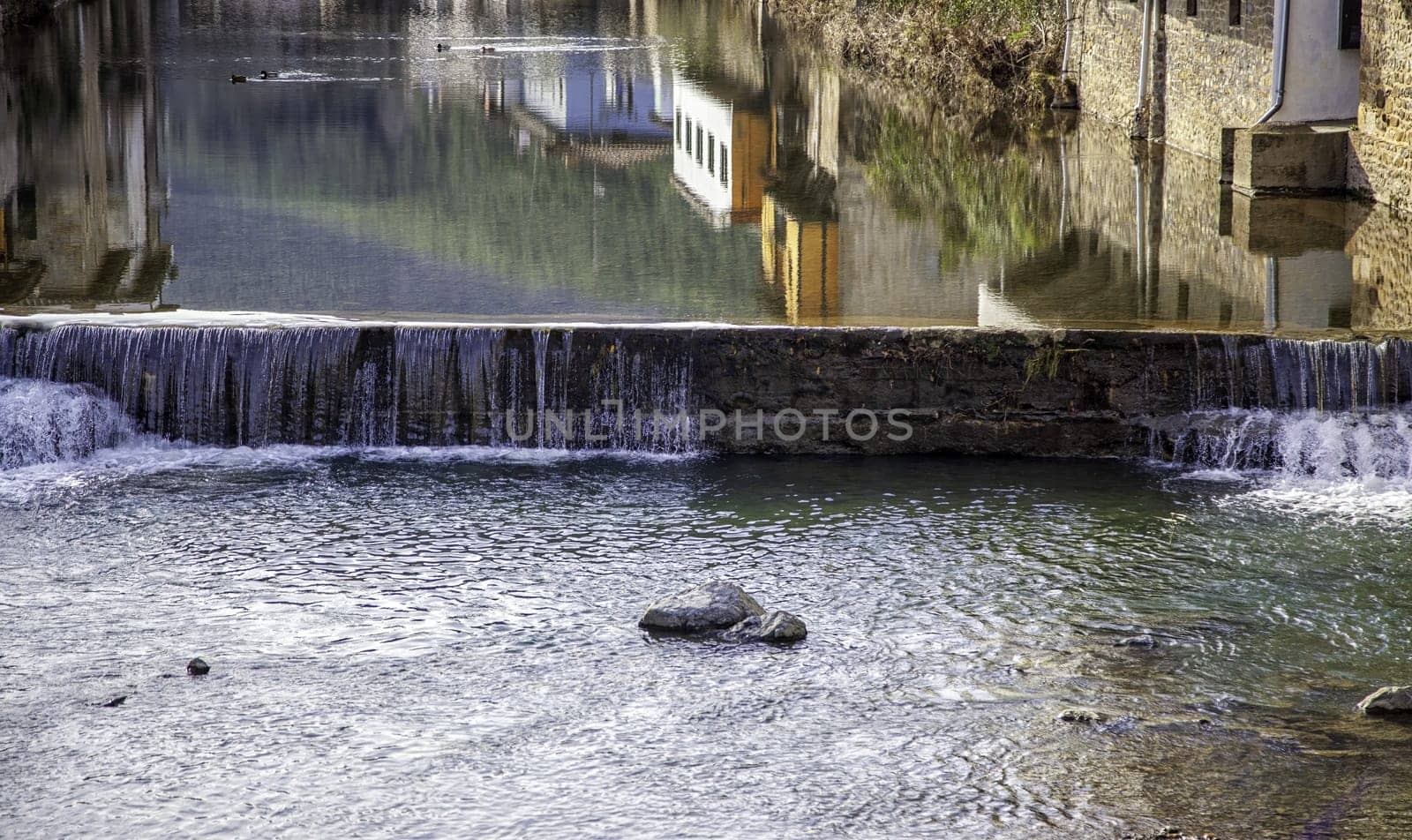 Detail of reflection in the water of a river in an old town