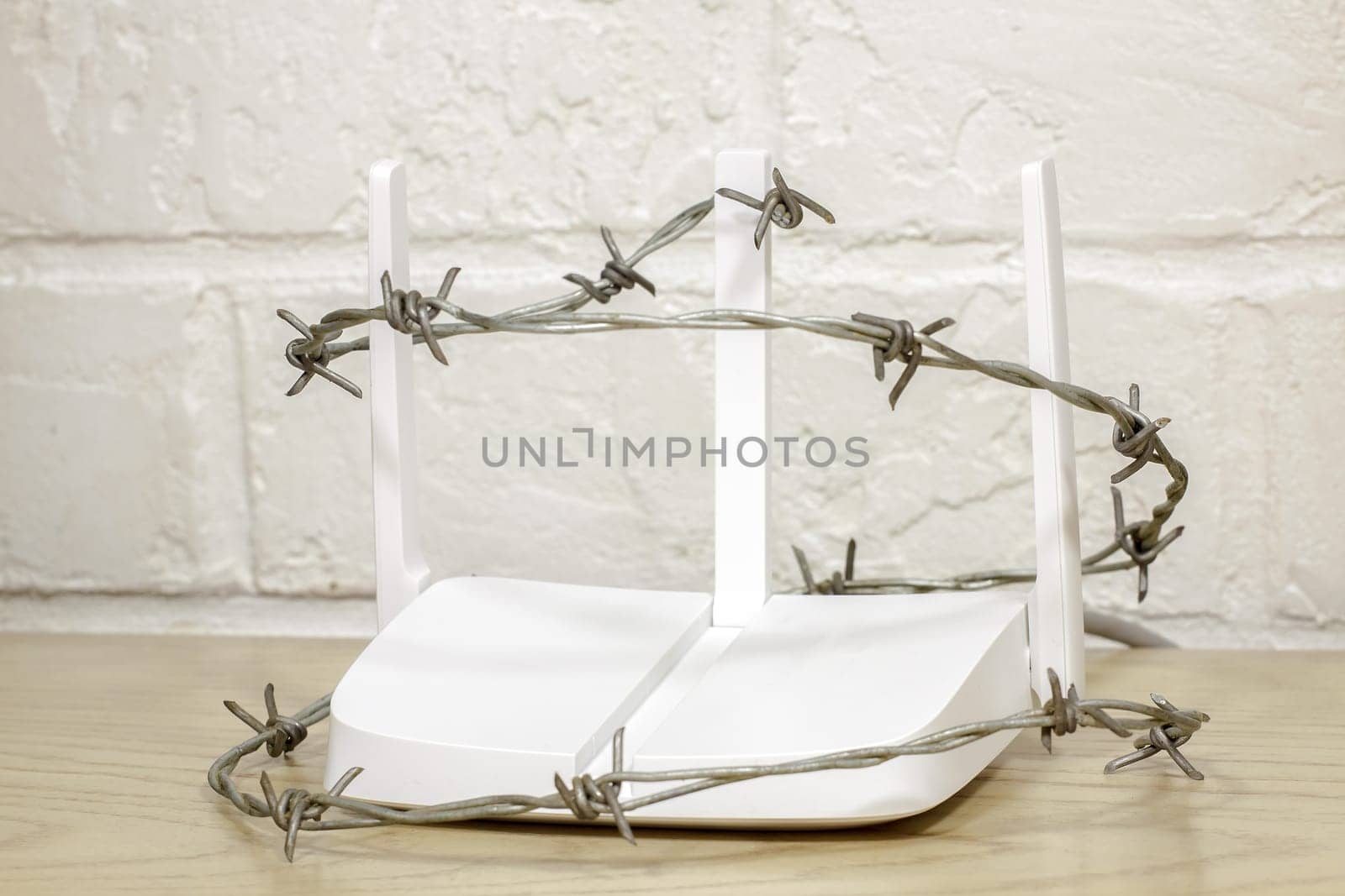Barbed wire around a home router with three antennas