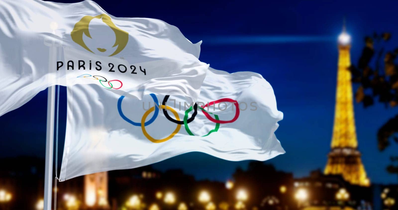 Paris, FR, June 1st 2024: Paris 2024 and the Olympics flags waving in the wind with blurred night Paris skyline in the background at night. Realistic 3d illustration. Illustrative editorial