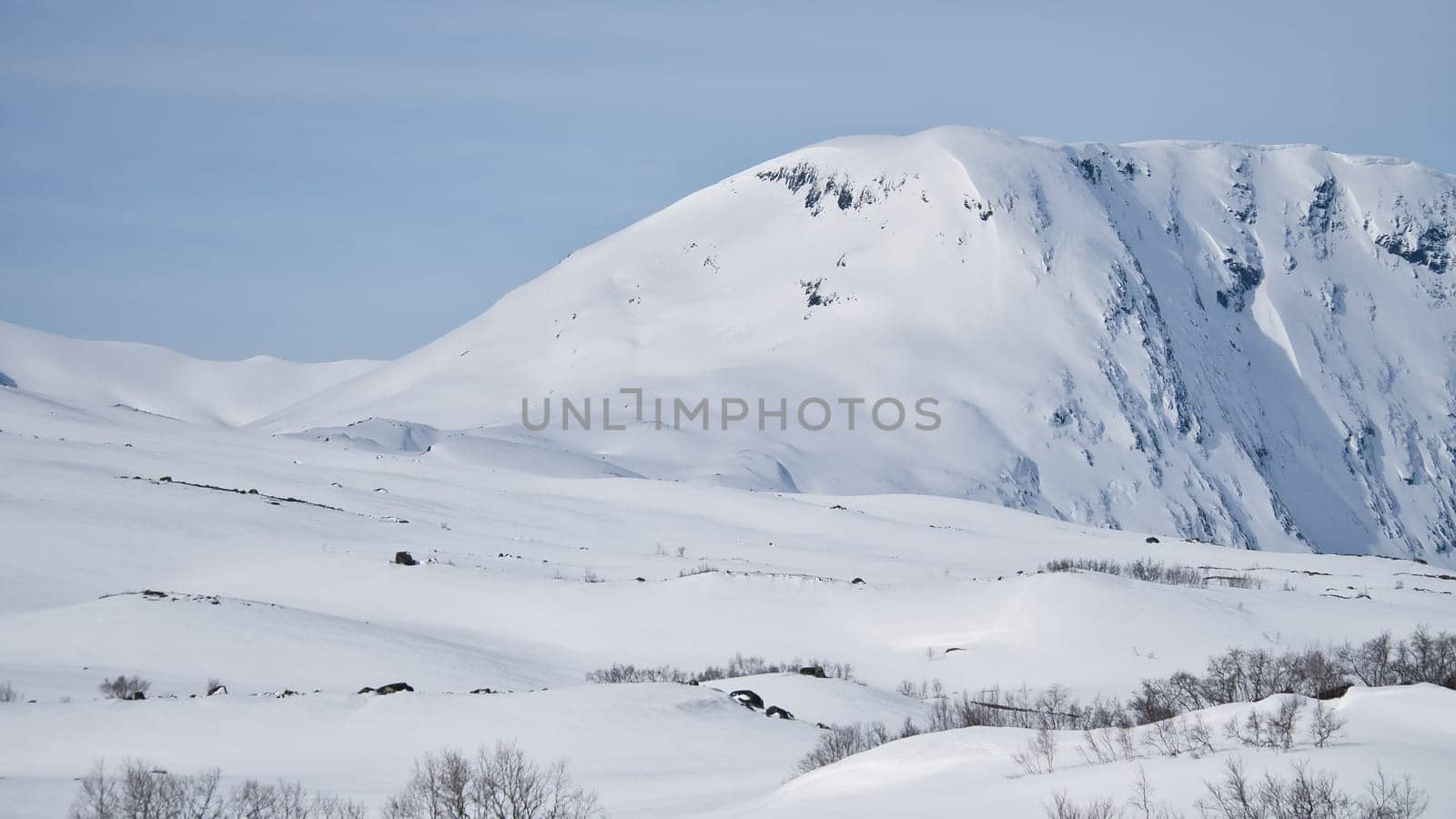Norwegian high mountains in the snow. Mountains covered in snow. Scandinavian landscape in the far north