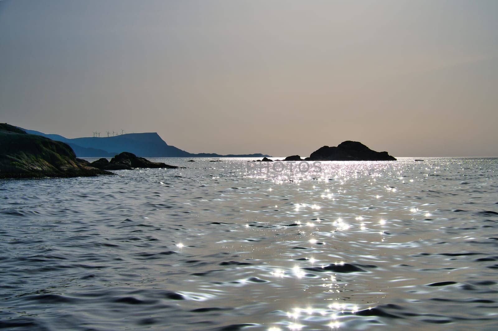 Norwegian fjord landscape. View of the open sea on the Western Cape. Crystal clear water, glistening in the sunshine. Landscape from Scandinavia