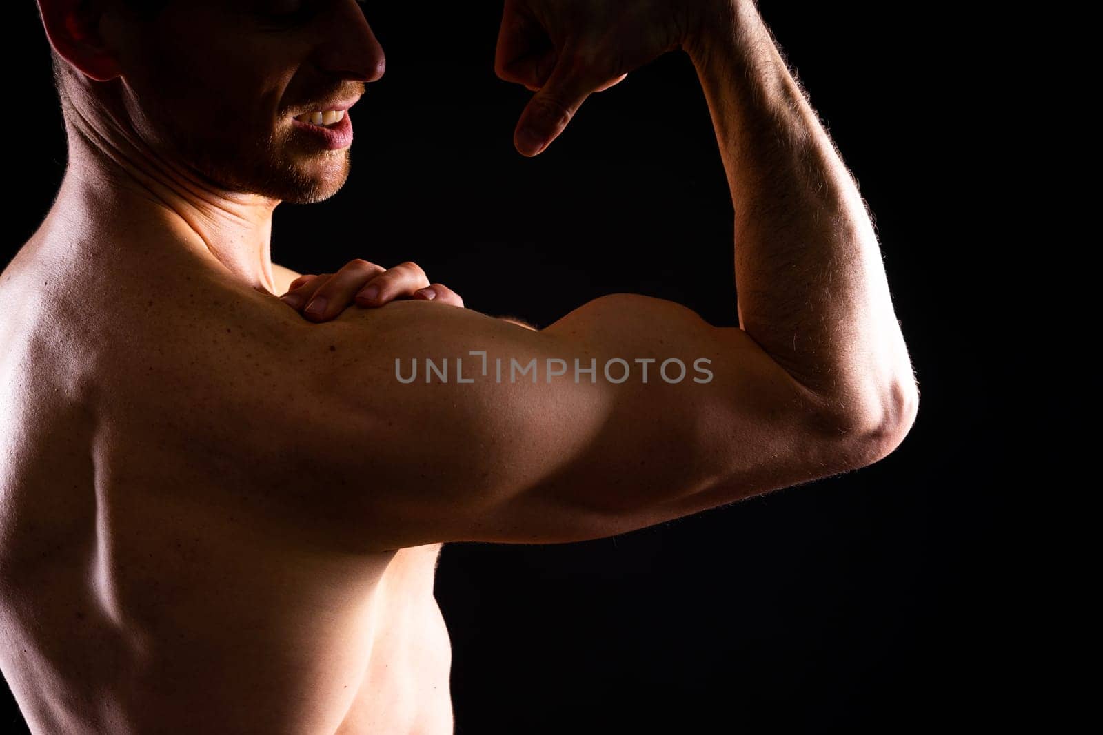 Portrait of man, bodybuilder and bicep flex in a studio, background and exercise for muscular power.
