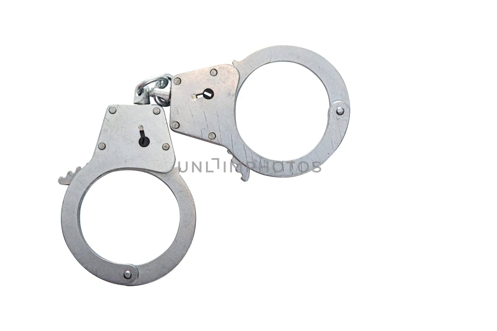 Metal handcuffs on a white isolated background, copy space. High quality photo