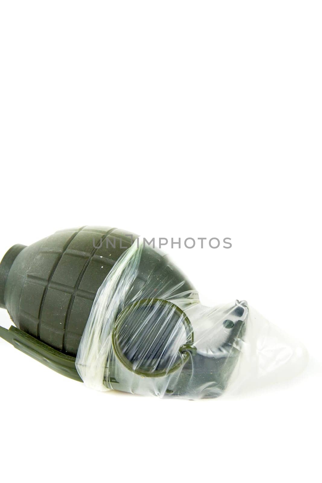 Condoms placed on a hand grenade on a white background