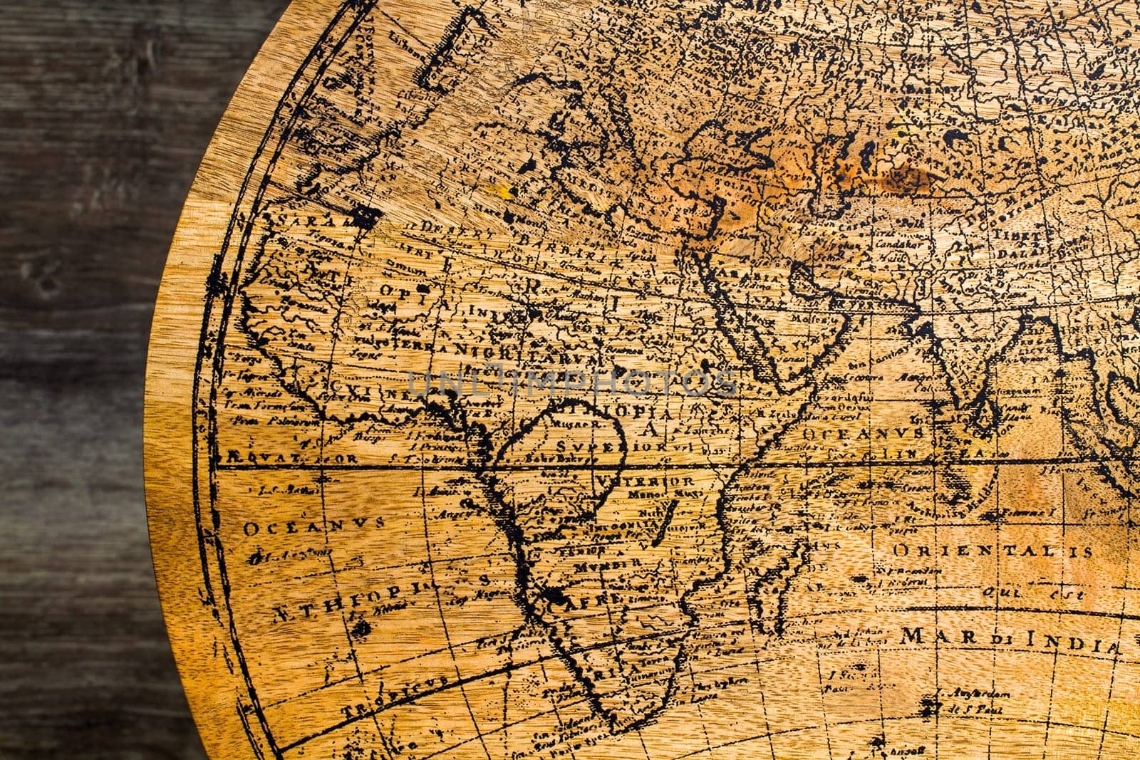 Old Geographic map of the world printed on a wooden board