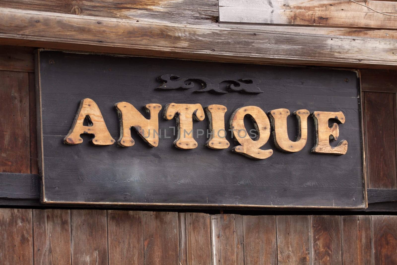 Detail of an old wooden fence with a sign
