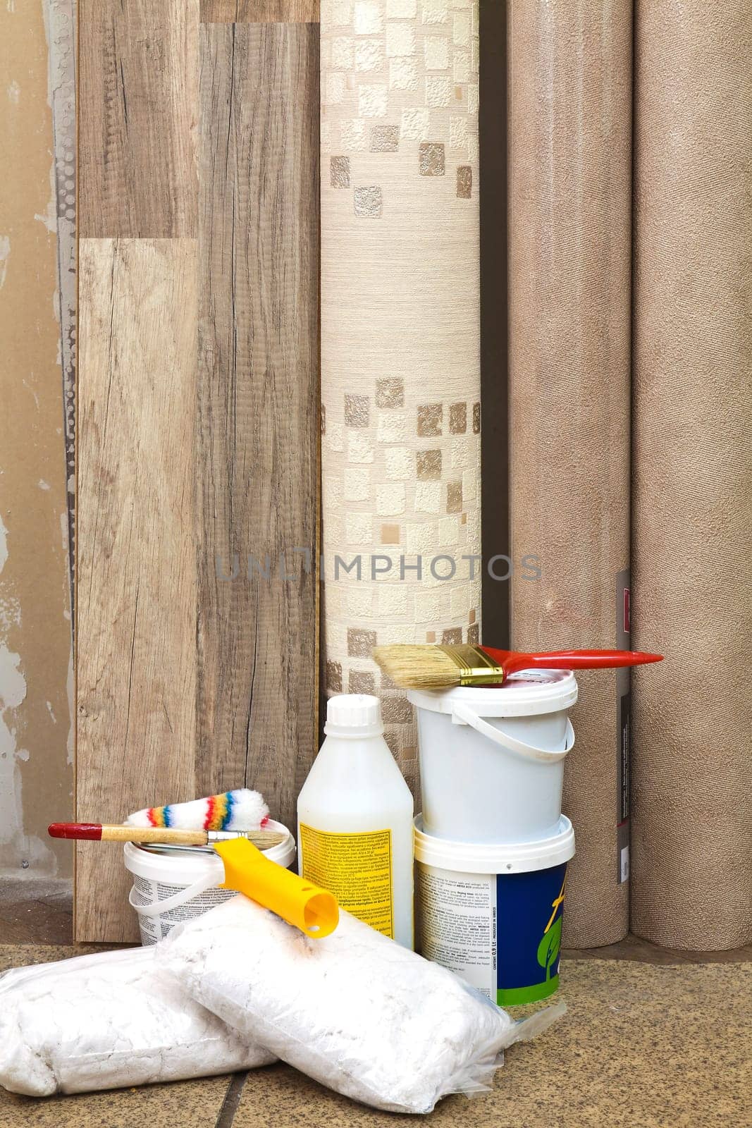 Laminate, vinyl wallpaper, paint cans and brushes to freshen the interior