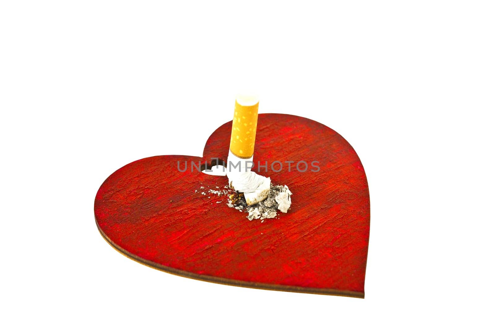Cigarette butt on red wooden heart isolated on white background - concept of harm from smoking