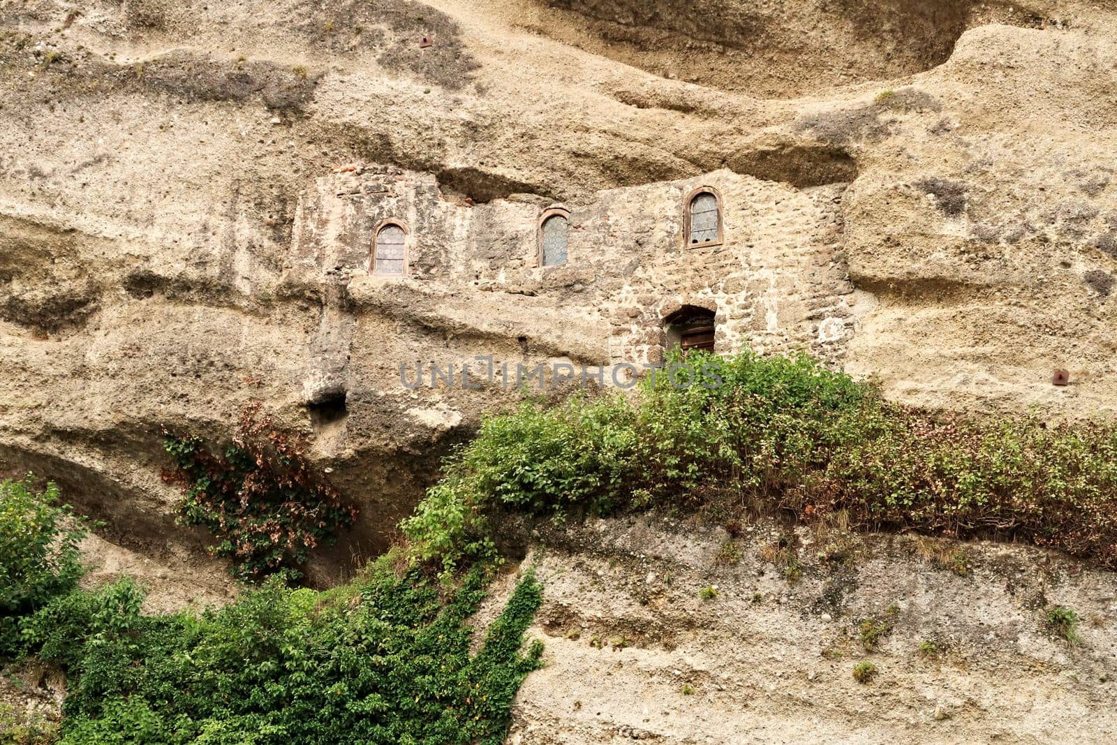 View onto the facade of the hidden Maximus Chapel, Cave, Maximuskapelle, Maximushöhle, built into a cave in a cliff of the Mönchsberg, part of the Catacombs of Salzburg at the St. Peter*s Cemetery, Salzburg, Austria 2022