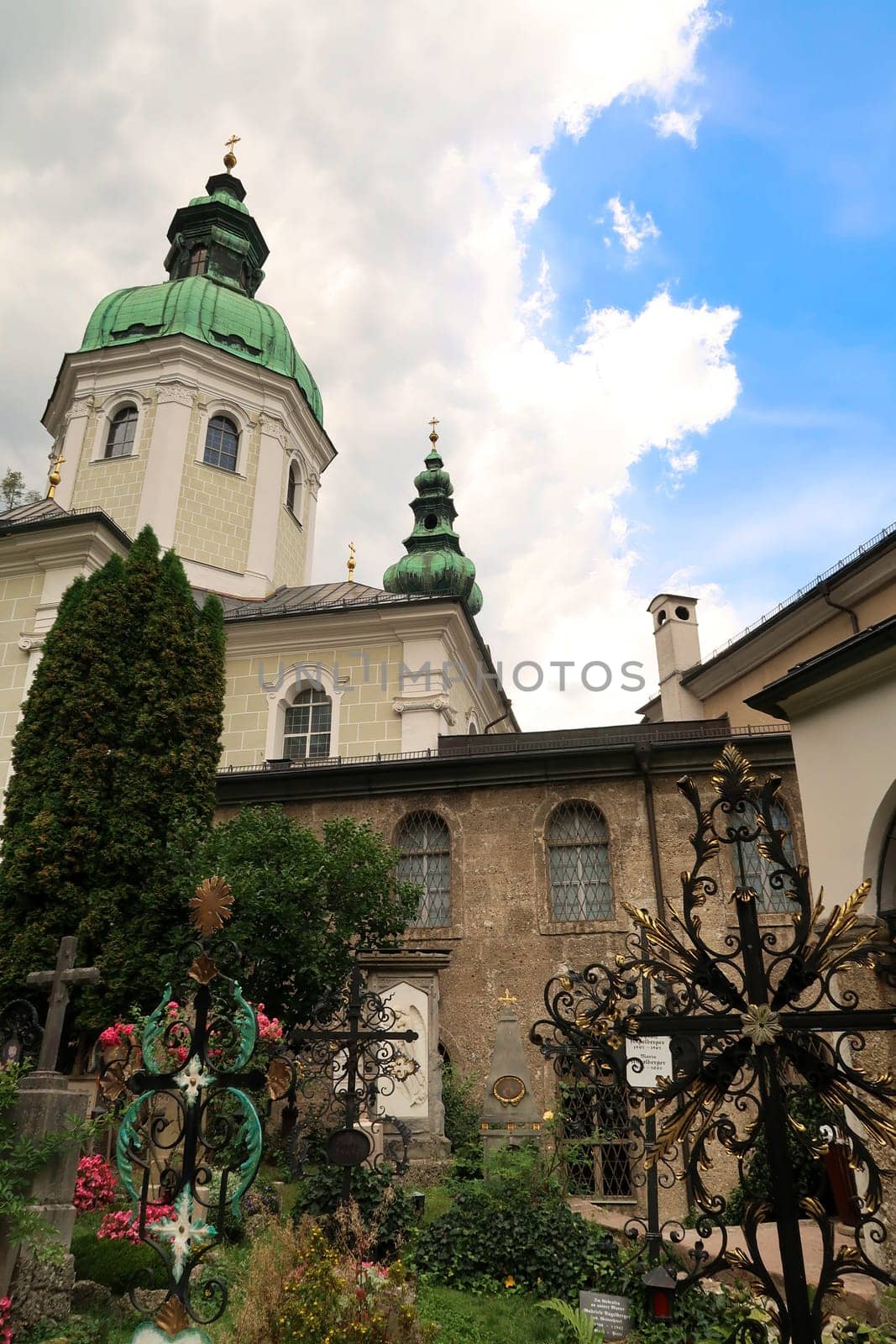Crosses of graves in front of the St. Peter's Abbey Church, Stiftskirche Sankt Peter and the Mariazell Chapel, Mariazeller Kapelle at the St., Saint Peter's Cemetery, Petersfriedhof, Salzburg, Austria 2022