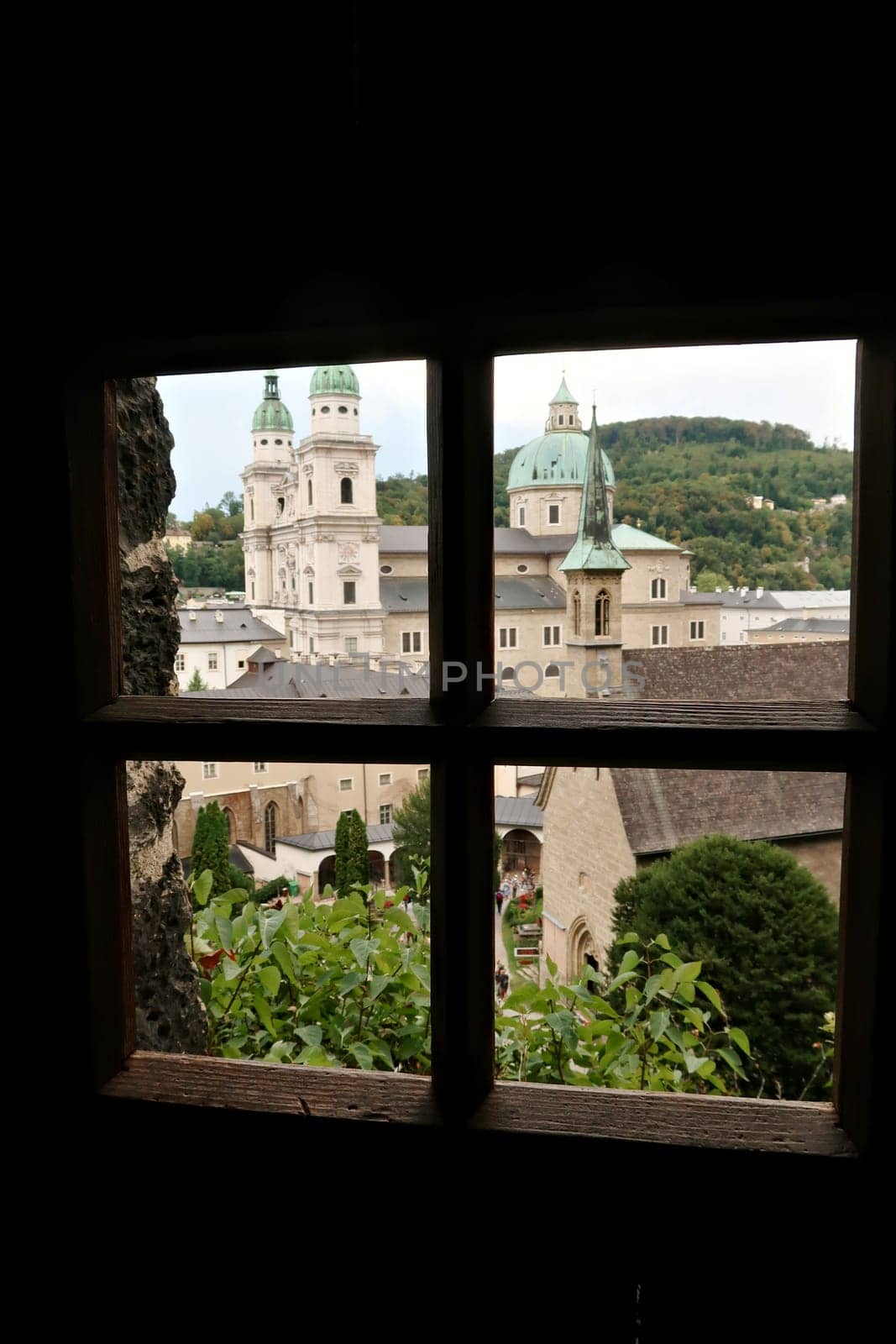 View onto the St. Peter's Cemetery from a window inside the Maximus Chapel, Cave, Maximuskapelle, Maximushöhle built into a cave in a cliff of the Mönchsberg, part of the Catacombs of Salzburg at the St. Peters Cemetery, Salzburg, Austria 2022