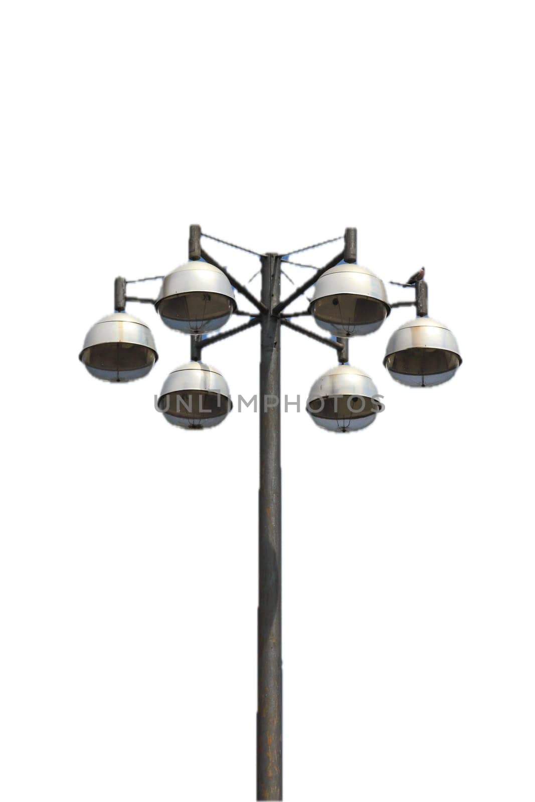 Street light with six lamps, and blue sky in the background