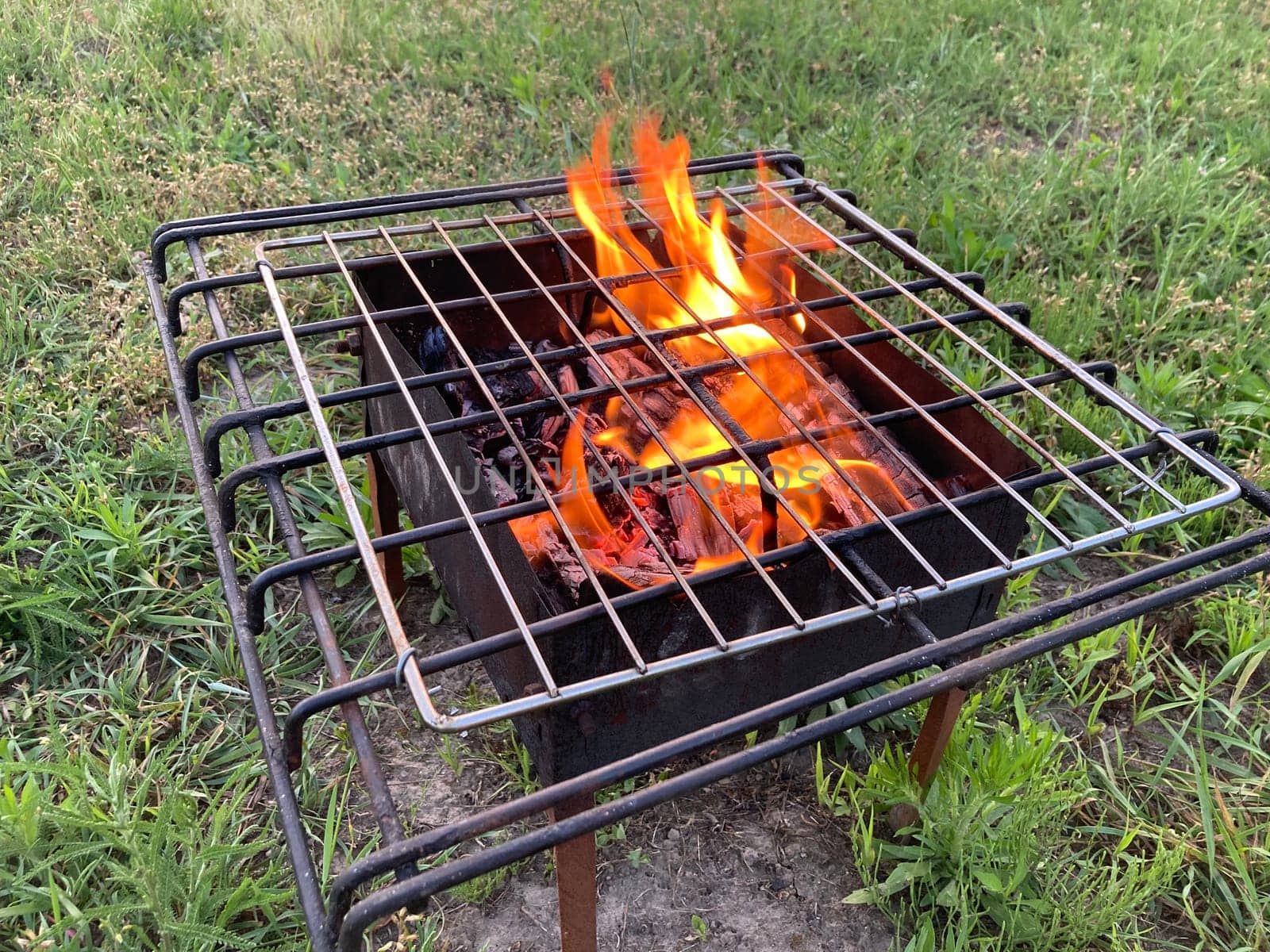 The barbecue grill is burning for frying shashlik on the coals