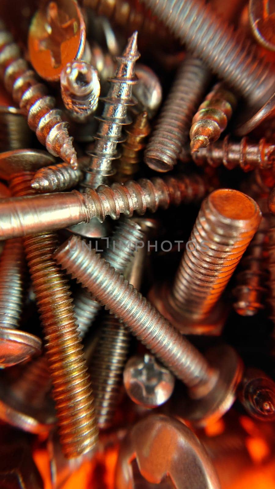 A bunch of different screws and connecting parts. Macrophotography.Texture or background.Selective focus.