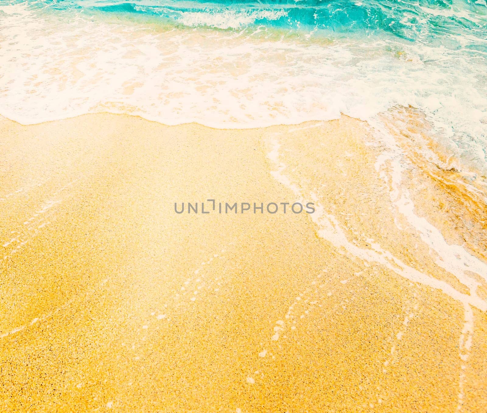 Tropical sandy beach and sea wave from above. Sand and water on tropical island top view. Exotic island summer holiday vacation background. Travel destination banner design.