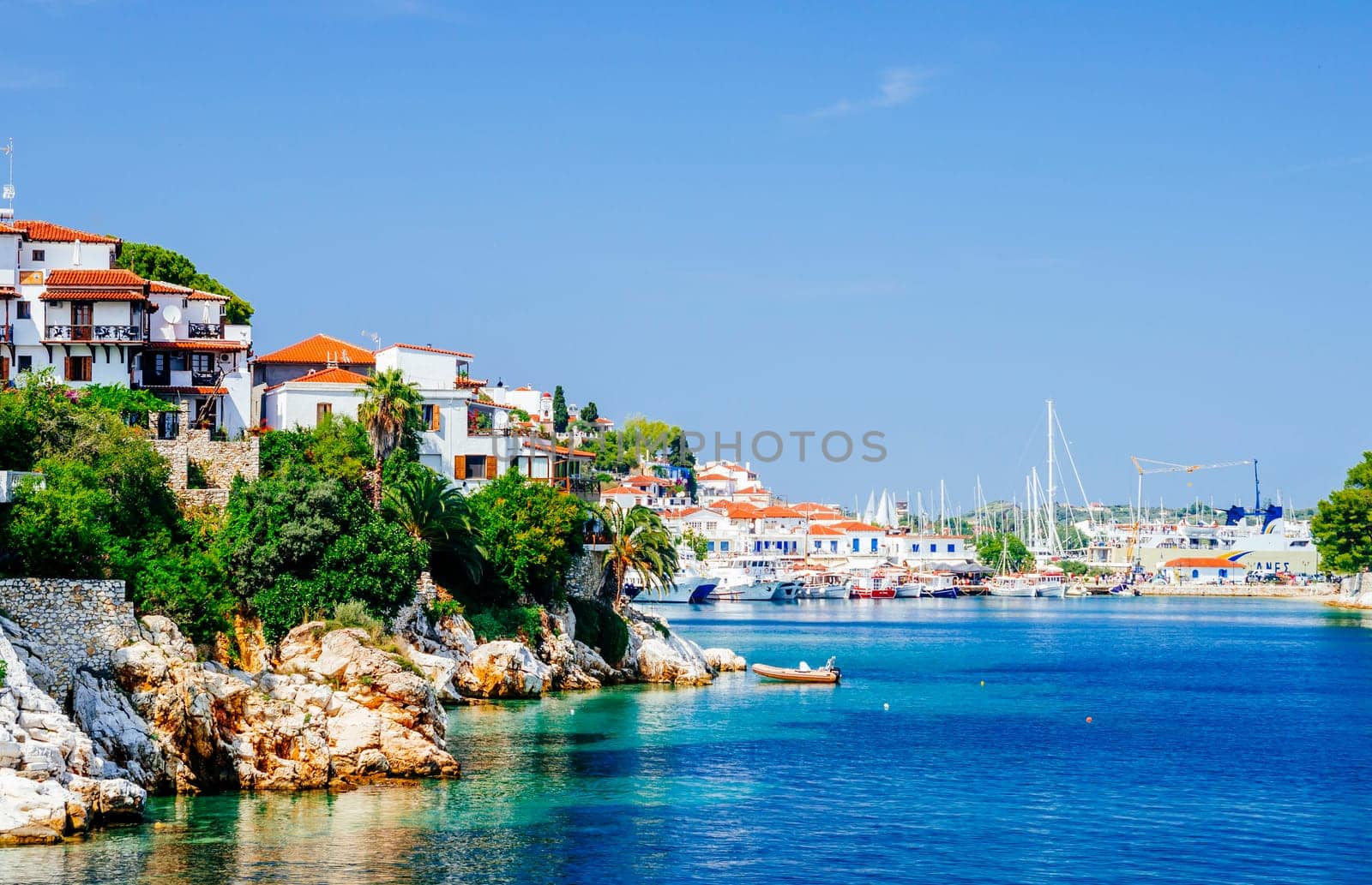 Old town view of Skiathos island, Sporades, Greece. Greek traditional architecture and aegean sea. Popular summer holiday destination scene.