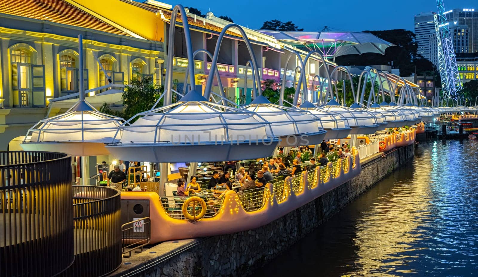 SINGAPORE - MAY 12, 2024: Clarke Quay after sunset, popular nightlife district of Singapore
