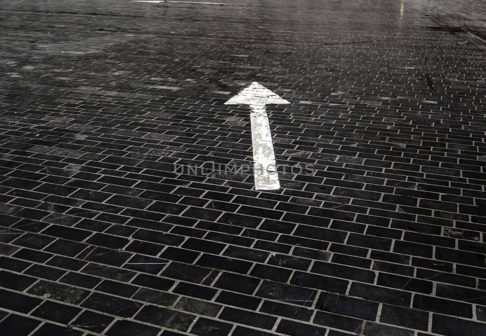 Detail of direction arrow for vehicles on a road