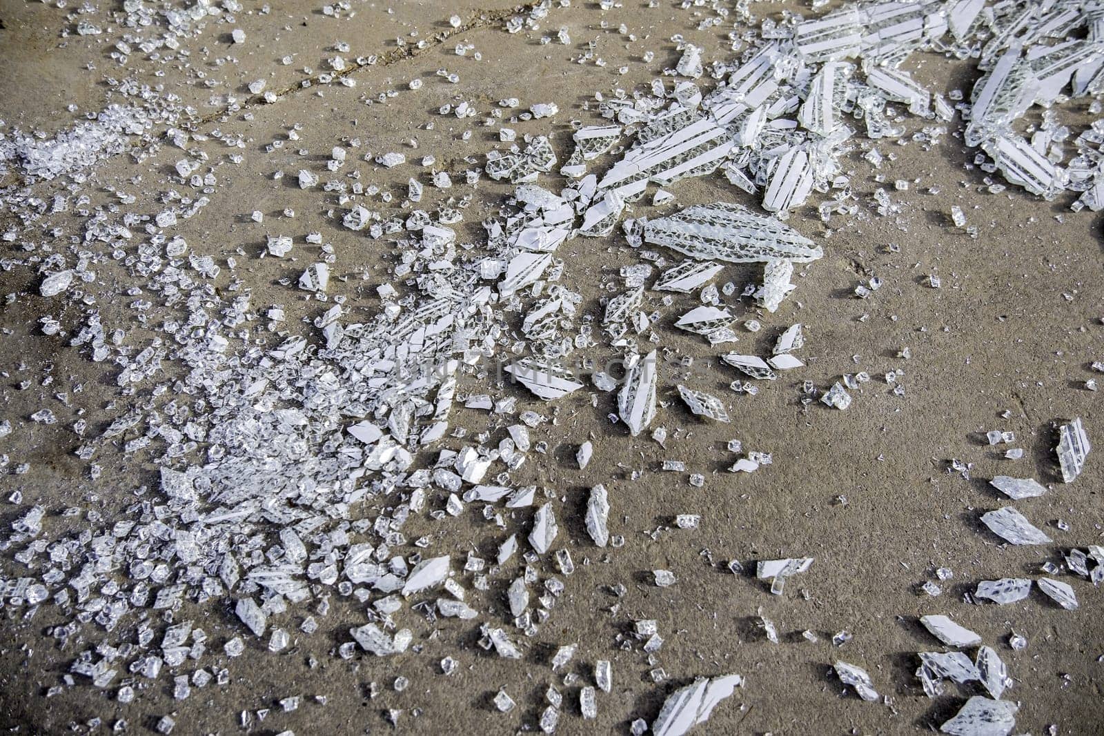 Detail of pieces of broken glass, vandalism and crime