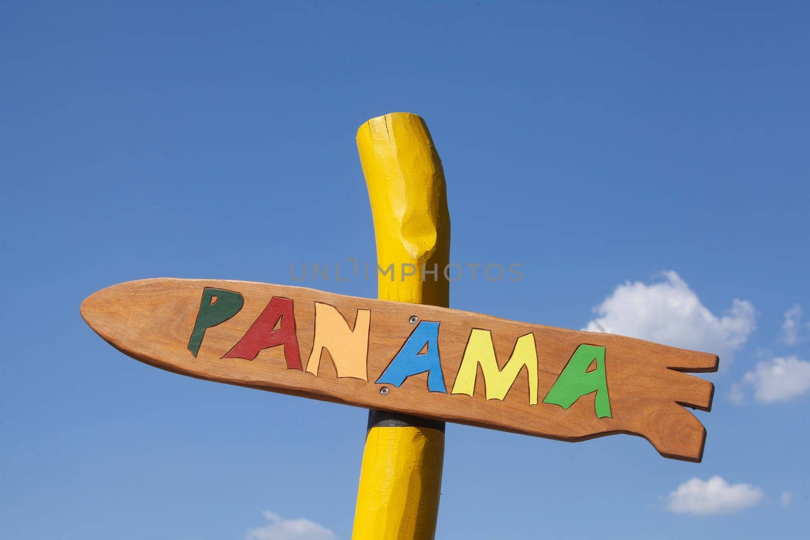 Colorful signpost to Panama with blue sky, Germany