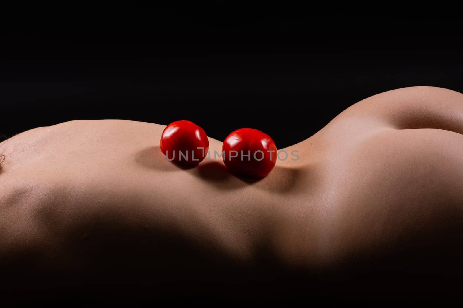 Red apple of Beautiful female body. Seductive booty of a young woman. Naked woman