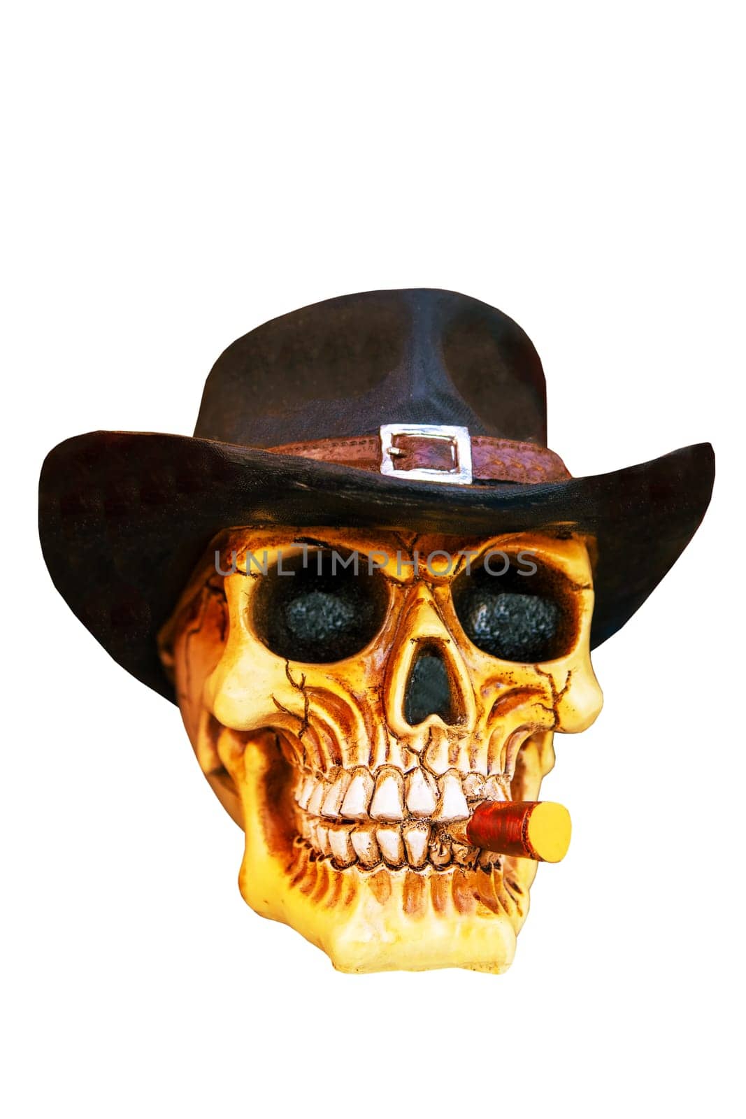 Closeup of scary human skull with vintage cowboy hat on his head and a cigar in his mouth isolated on a white background. Clipping path.