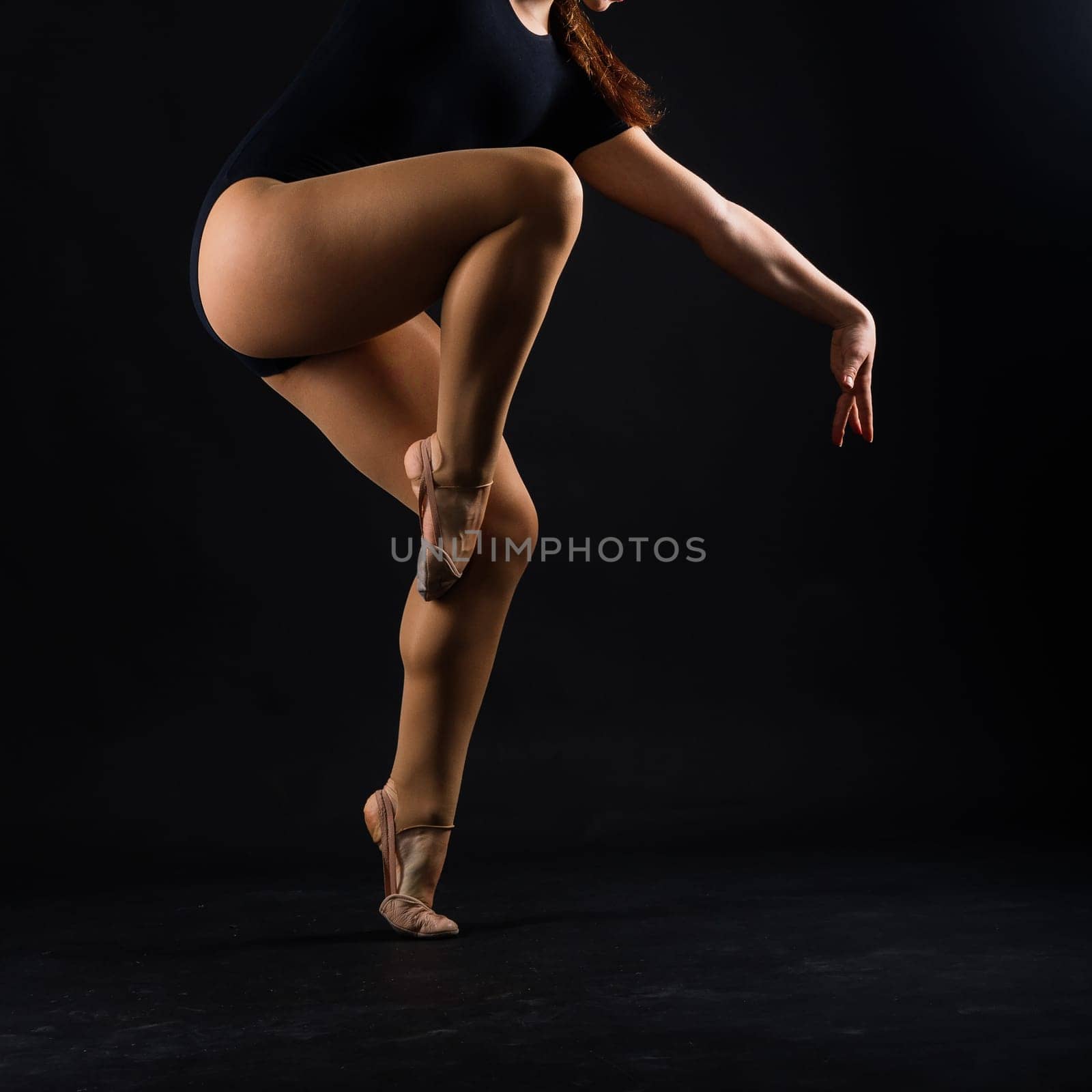 Beautiful cool young fit gymnast woman in a sportswear dress working out, performing art gymnastics
