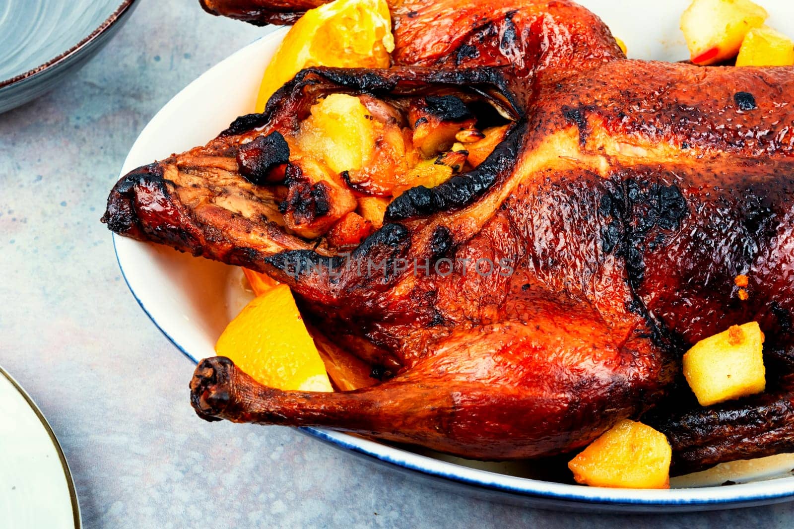 Appetizing duck baked with oranges and caramelized apples.