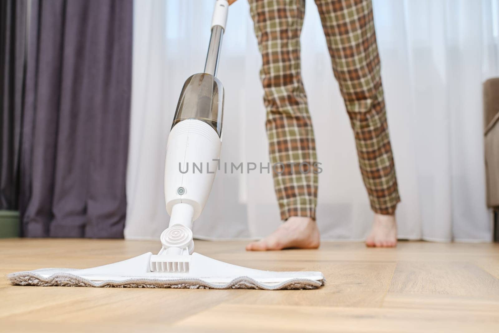 Closeup view of mopping floors with modern swab