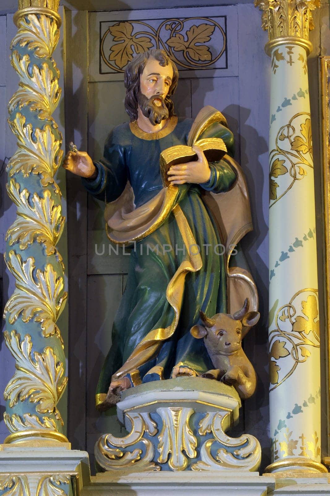 Saint Luke the Evangelist, statue on High altar in the Parish Church of Exaltation of the Holy Cross in Kriz, Croatia