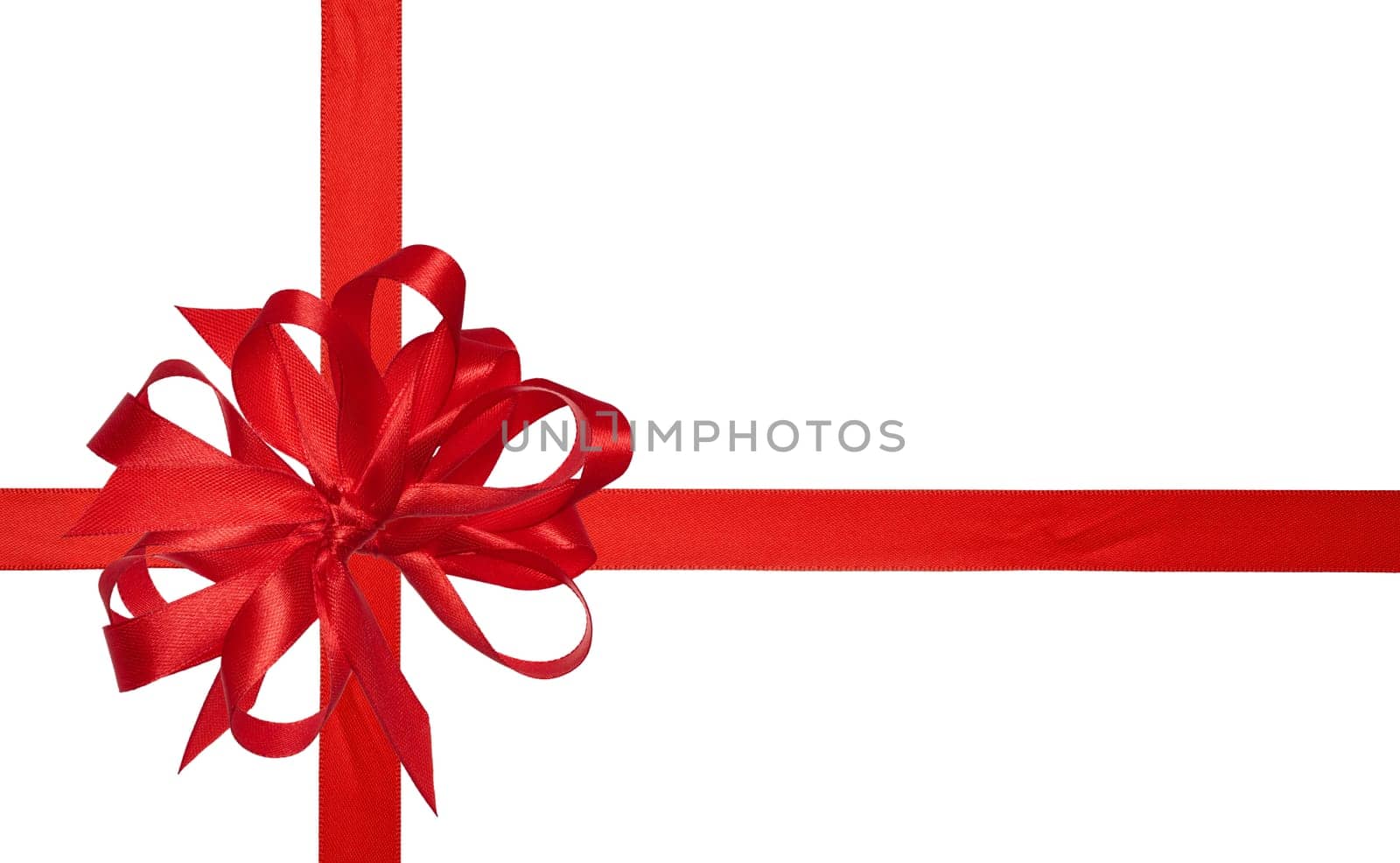 Red silk ribbon and a tied big bow on an isolated background, top view