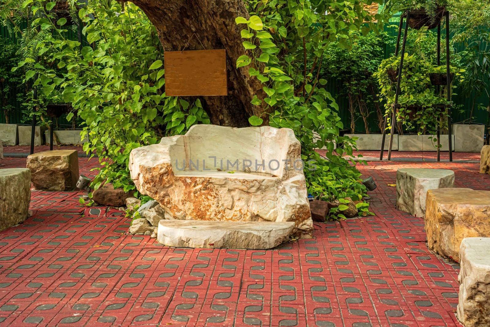 A large stone made into a chair to decorate the garden.
