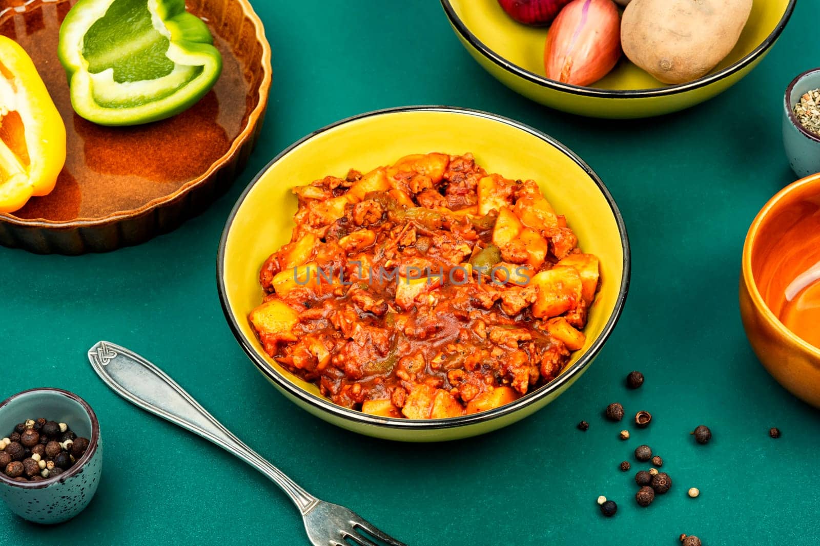 Stewed potatoes with minced turkey on rustic and wooden table. German cuisine. Ragout