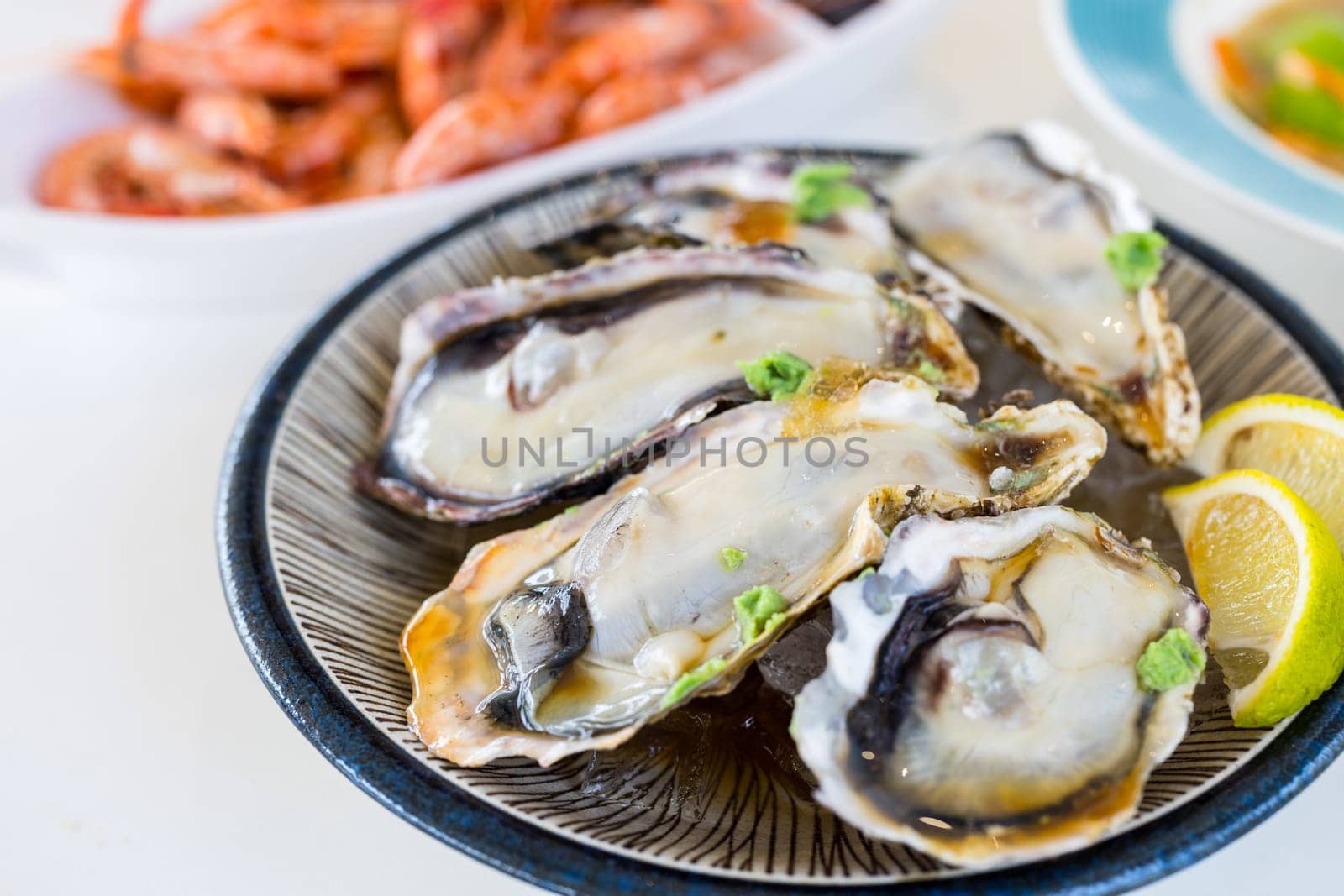 Tasty fresh raw oyster on the plate in restaurant