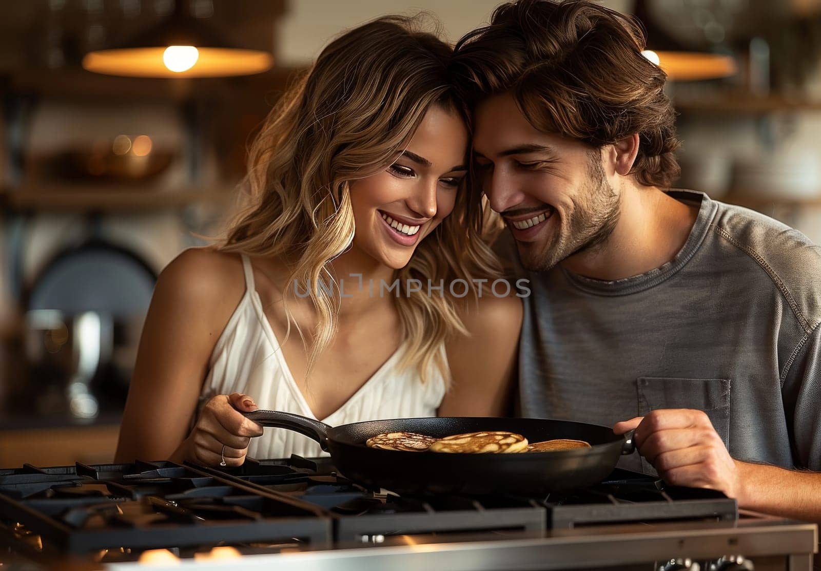 A joyful young couple is seen engaged in cooking pancakes in a cozy, warmly-lit kitchen, sharing an intimate and cheerful moment together