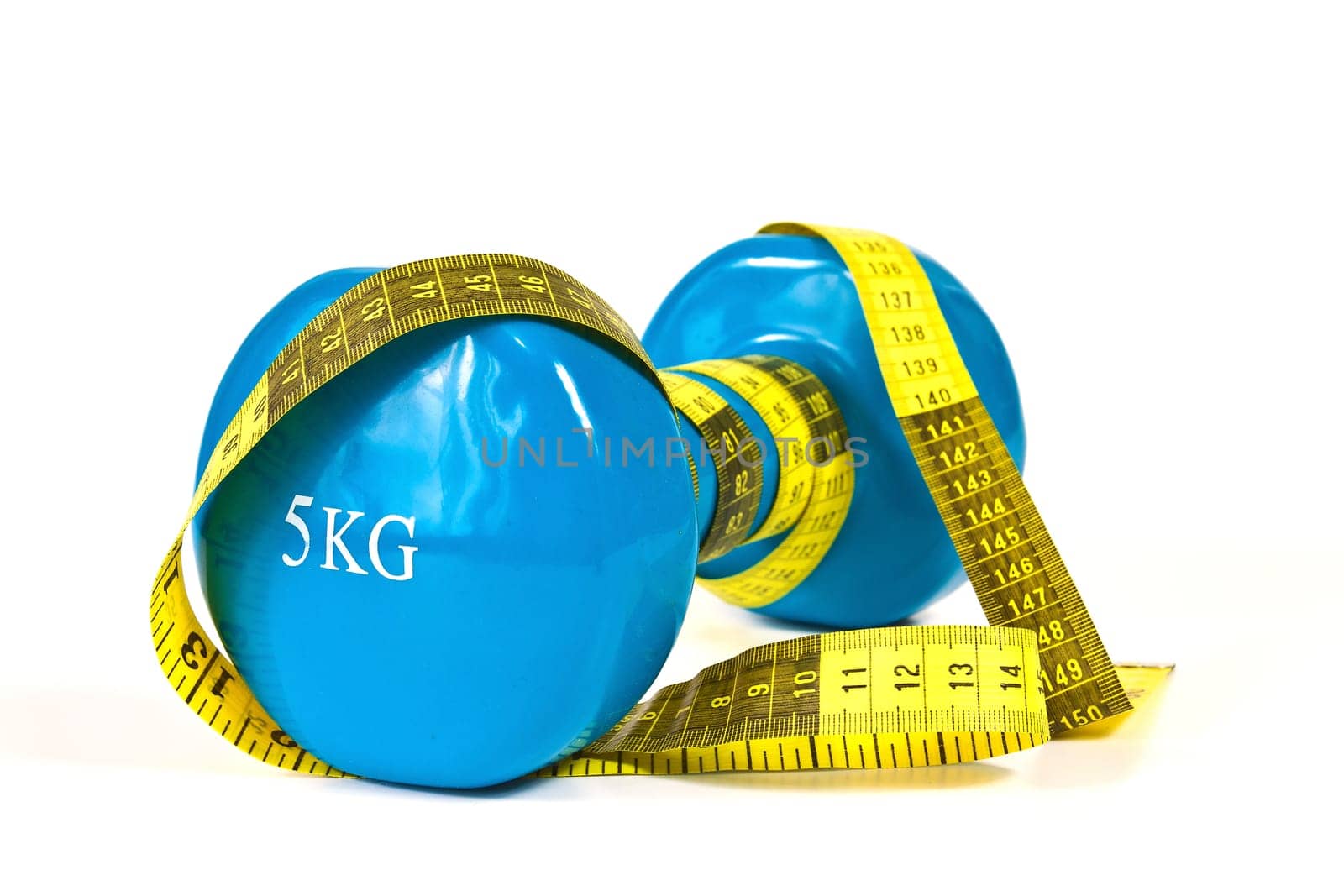 Gymnastics dumbbell and tape measure on a white background