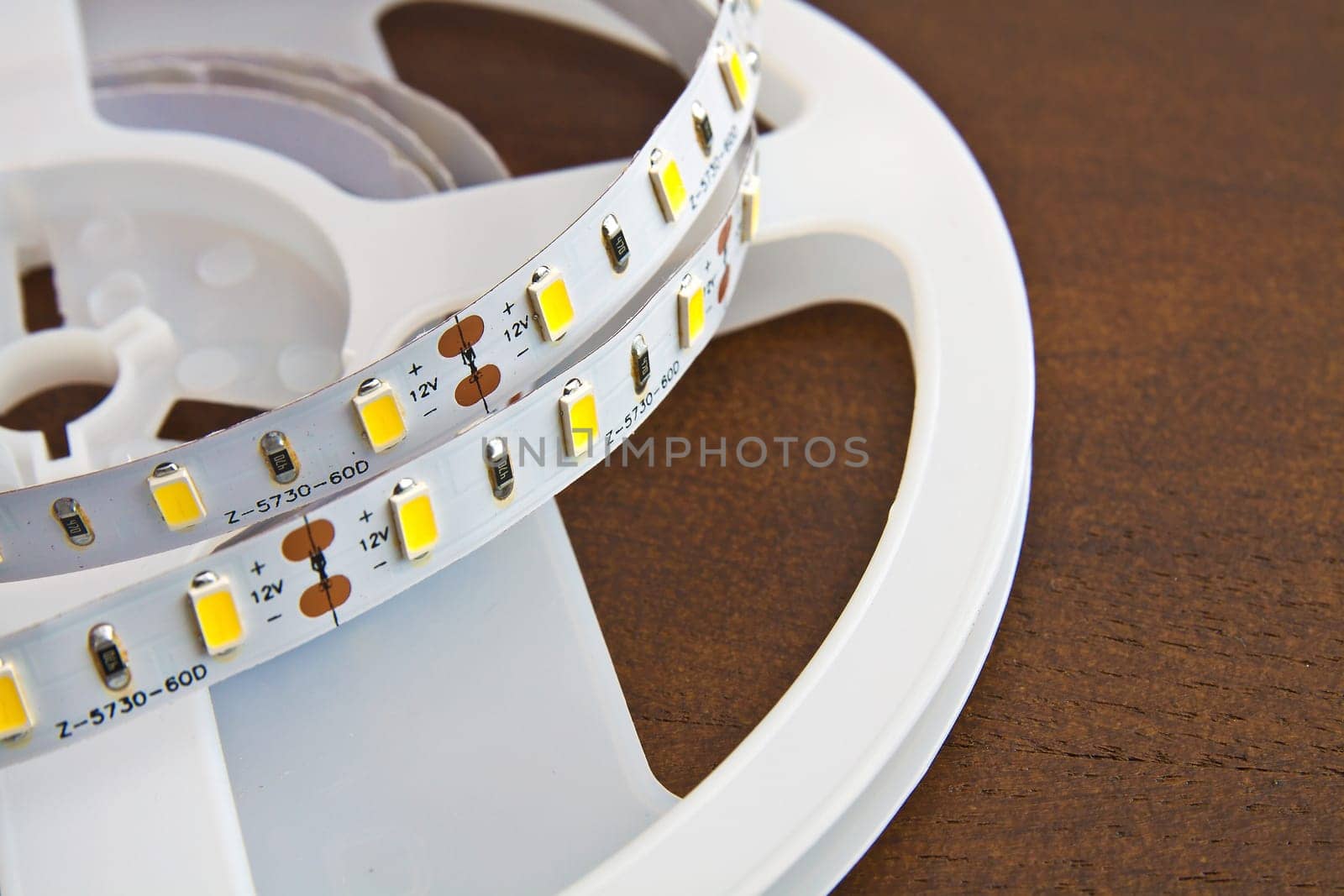 LED strip wound on a roll of brown wooden board
