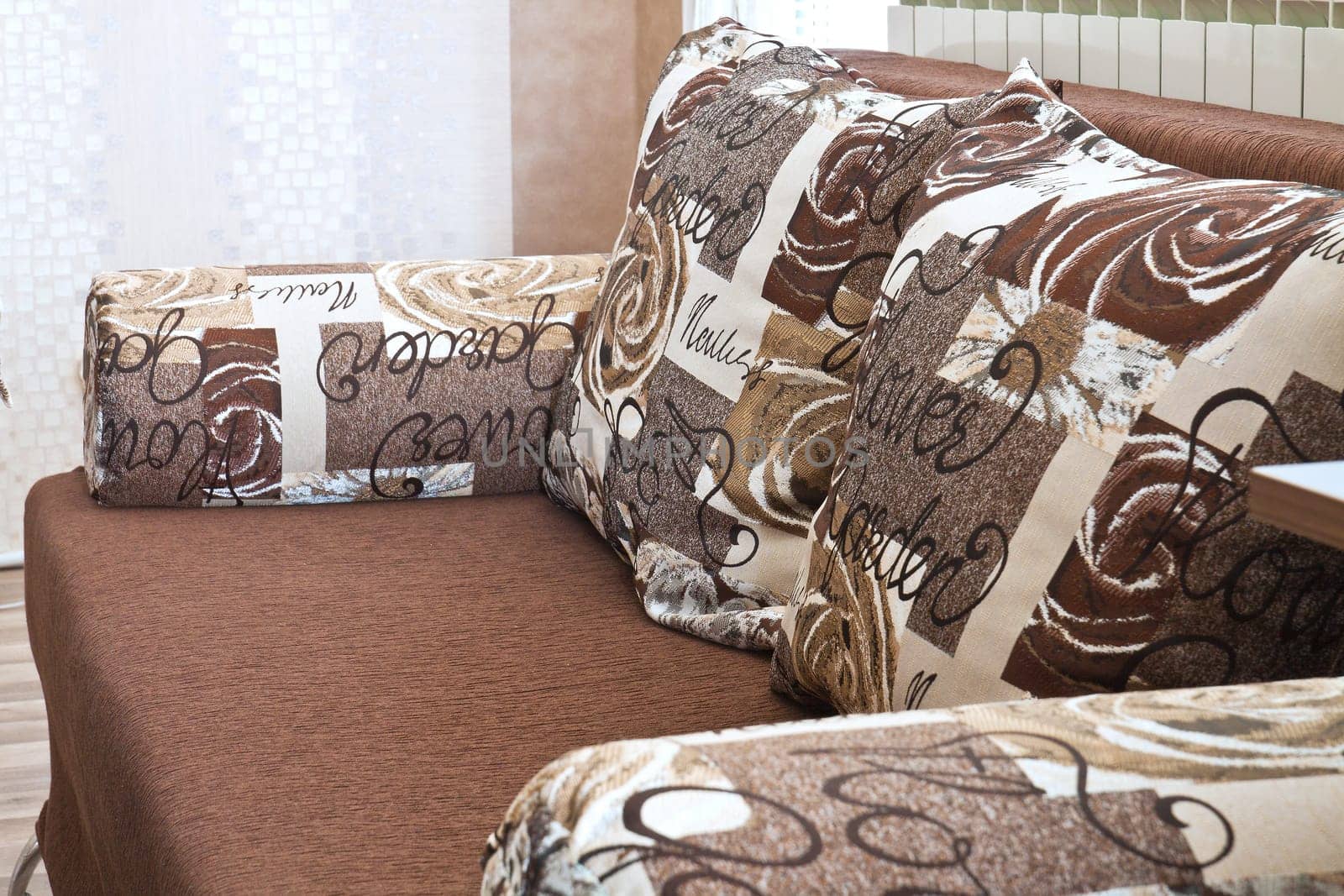 Detail from home sofa with pillows in beige brown tones