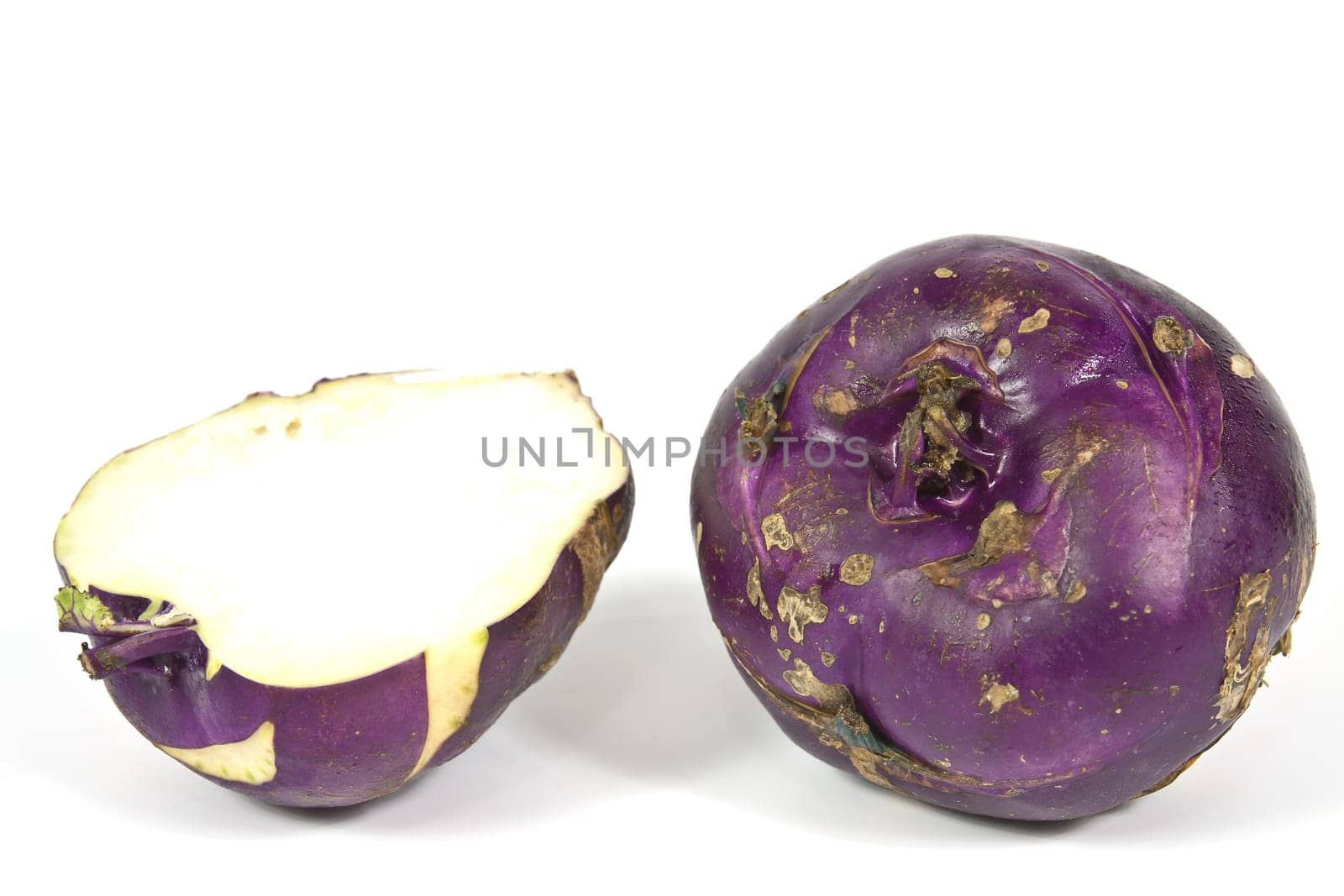 Kohlrabi vegetable with a rounded stem with dark purple color on a white background