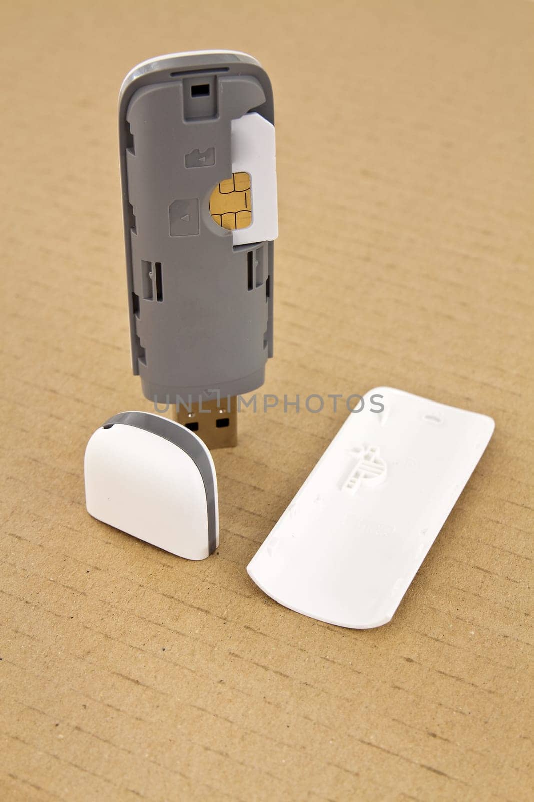 Wireless modem with a SIM card on a base of cardboard