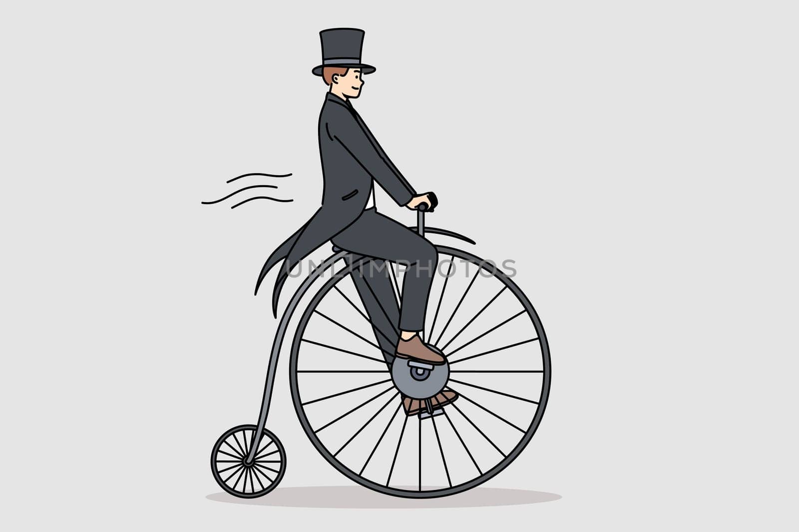 Man in tailcoat rides vintage penny farthing bicycle, imagining time travel to last century. Guy uses fancy bicycle while performing on circus stage to surprise audience who came to show.