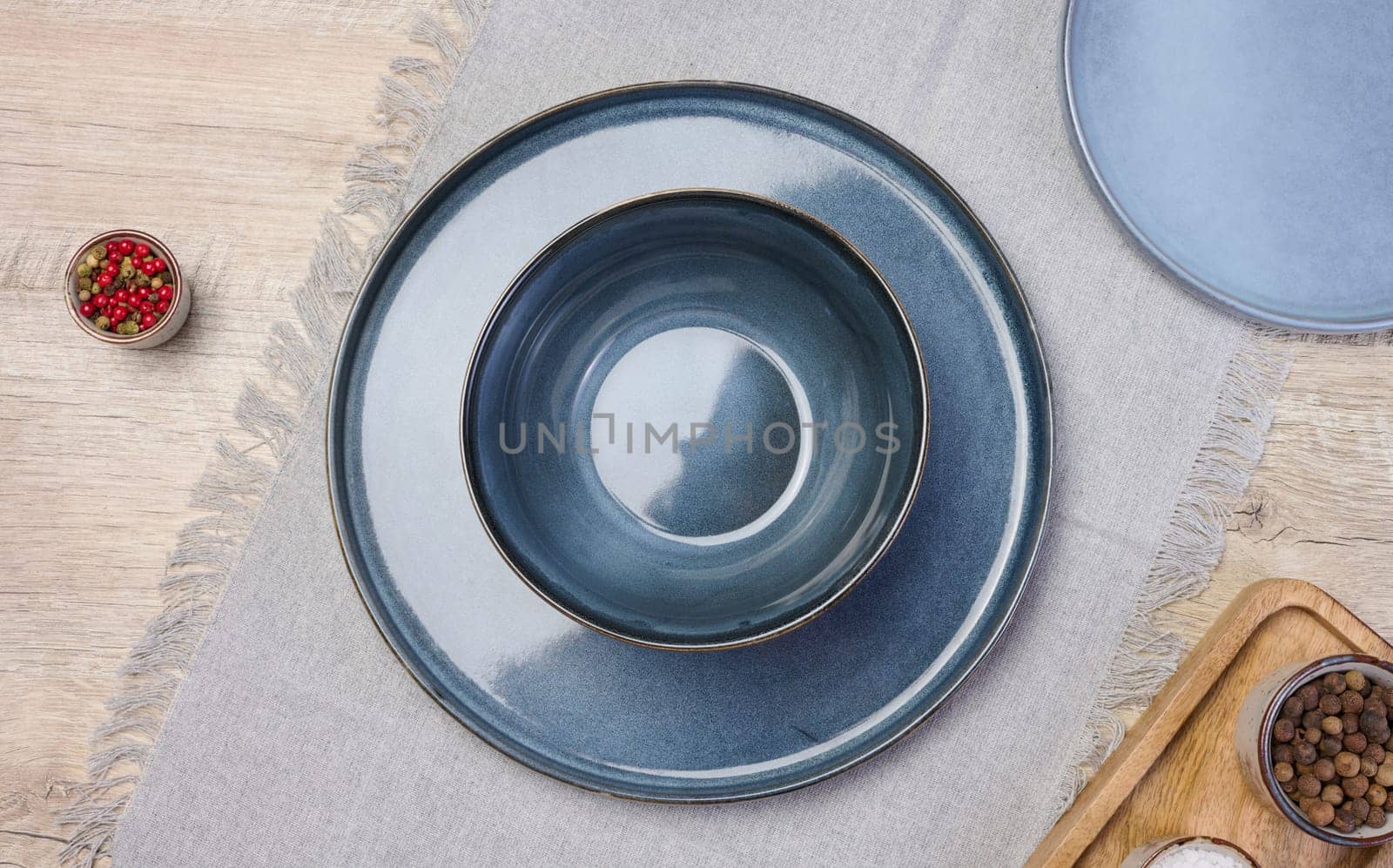 Empty blue round ceramic plate on the table, top view
